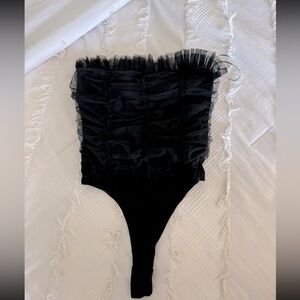 Strapless black bodysuit with ruffles